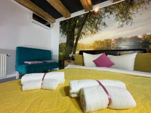 a bedroom with a large bed with a painting on the wall at Smart Studio free parking in Craiova
