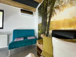 a room with a blue couch and a tree mural at Smart Studio free parking in Craiova