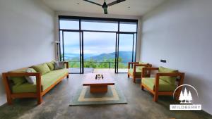 a living room with two couches and a table at Wildberry Galaha in Kandy +28 photos
