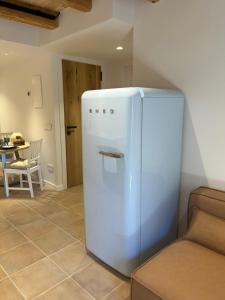 a white refrigerator in a room with a table at CAL PASSACOSTES cb in Solsona