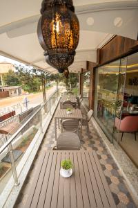 a row of tables in a building with a chandelier at VRR Astoria Hotel & Convention Center in Bengaluru
