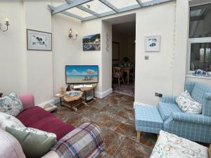a living room with two couches and a tv at Pip's Corner in Lynton