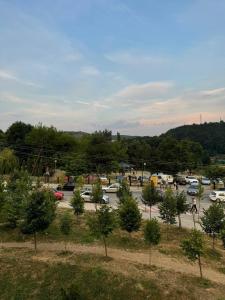 a parking lot with cars parked in a parking lot at Parkside Cozy Retreat in Pristina