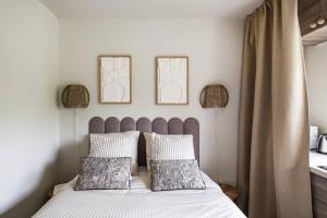 a bedroom with a bed with two pictures on the wall at Bali Lake - Duke Housing in Créteil +8 photos