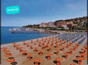 a bunch of umbrellas and chairs on a beach at Villa DTS3 in Kaštel