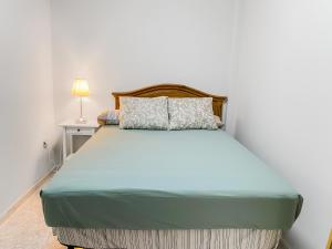 ein Schlafzimmer mit einem großen Bett mit einem hölzernen Kopfteil in der Unterkunft Beachhouse Gran Tarajal 3BR in Gran Tarajal