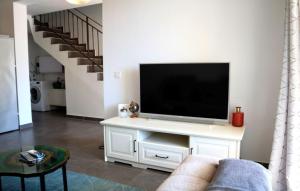 a living room with a flat screen tv on a white entertainment center at Beautiful Villa Piccolo Paradiso in Novigrad in Bužinija