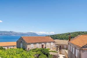 a group of houses with the ocean in the background at Pinta Apartments in Lumbarda