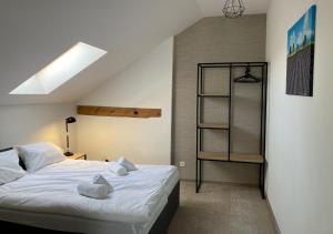 a bedroom with a bed and a book shelf at Folwark Matecznik - Dworek in Sęzinko