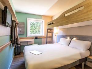Postel nebo postele na pokoji v ubytování Ibis Budget Lyon Est Saint Quentin Fallavier