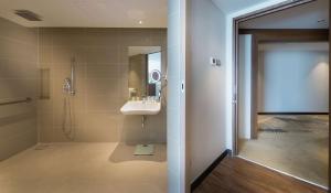 a bathroom with a sink and a shower at DoubleTree Resort by Hilton Hotel Penang in Batu Ferringhi