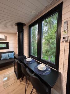 a room with a table and two chairs and a stove at The Saunacabin Enchanted Lapland in Rovaniemi