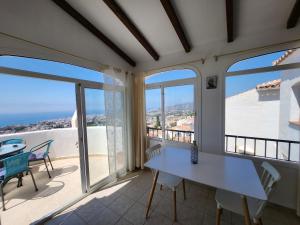 a dining room with a table and views of the ocean at R1370 Mandarinos 61 in El Molino