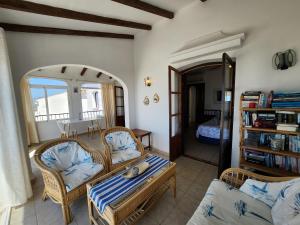 a living room with two chairs and a table at R1370 Mandarinos 61 in El Molino