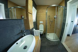 a bathroom with a sink and a shower at Apartman Fjaka in Petrcane +38 photos