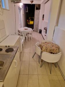 a kitchen with a table and chairs and a table at Kostic Apartments in Buljarica +6 photos