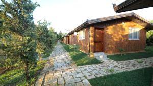 a house with a stone path next to a building at Sirena Agroturizem in (( Stan i Ri ))