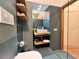 a bathroom with a sink and a toilet and a mirror at Elegant 3 bedrooms apartment Colosseum - San Giovanni in Rome +48 photos