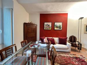 a living room with a couch and a glass table at Elegant 3 bedrooms apartment Colosseum - San Giovanni in Rome