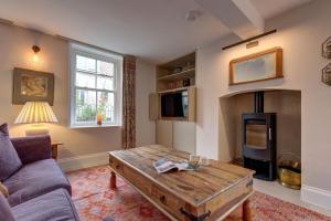 a living room with a coffee table and a fireplace at Beresford House in Wells next the Sea