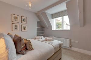 a bedroom with a bed and a window at Beresford House in Wells next the Sea