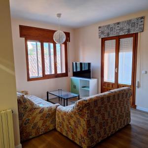 a living room with a couch and a tv at Casa Buenavista Vut in Revenga +18 photos