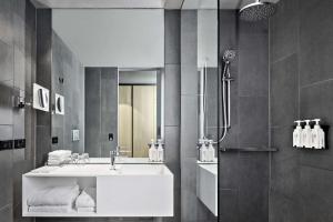 a bathroom with a sink and a mirror at Vibe Hotel Melbourne Docklands in Melbourne