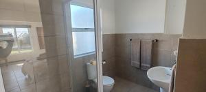 a bathroom with a toilet and a sink at Klipvis at Duykereiland in St Helena Bay +18 photos