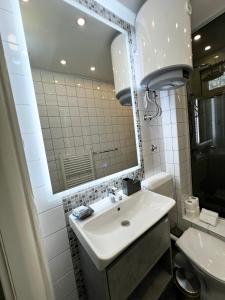 a bathroom with a sink and a mirror and a toilet at No1 Apartments in heart of Sarajevo in Sarajevo +22 photos