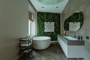 a bathroom with a tub and a sink at Luxury Smart Home Apartment in Vilnius Old Town, Sleep on Hästens in Vilnius +71 photos