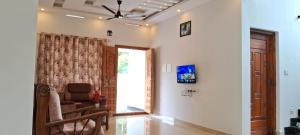 a living room with a chair and a door at Rockland Holidays Ramakkalmettu in Idukki