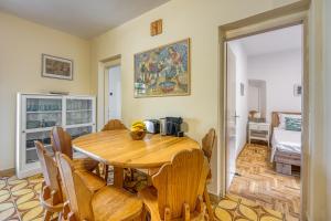 a dining room with a wooden table and chairs at Old Bay Leave Town Apartment - Happy Rentals in Mali Lošinj