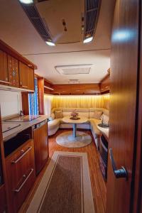 a kitchen and living room with a couch and a table at Каравани AVI IRIS Фичоза in Varna City
