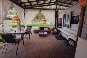 an rv with a table and chairs and a table and chairs and a patio at Каравани AVI IRIS Фичоза in Varna City