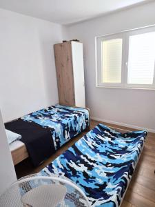 a small room with a bed and a chair and window at New 2 Bedroom, 2 Bathroom Apartment in Pisak in Pisak +15 photos