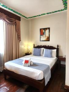 Postel nebo postele na pokoji v ubytování NSCC Hotel Vigan