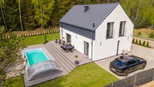 an overhead view of a white house with a swimming pool at Luxury House Masuria in Nidzica