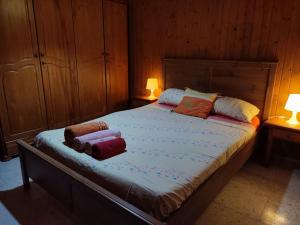 a bedroom with a bed with two towels on it at Casa Athenea in Conil de la Frontera