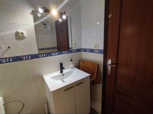 a bathroom with a sink and a mirror at Casa Athenea in Conil de la Frontera +11 photos