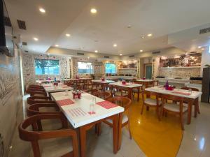 a restaurant with tables and chairs in a room at Ginger Pondicherry in Pondicherry