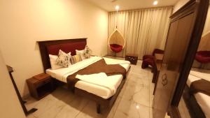 a hotel room with a bed and a window at Hotel Cityscape in Chandīgarh
