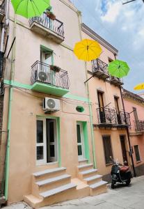 a building with two umbrellas on the balcony at Ciao Iglesias 2 in Iglesias