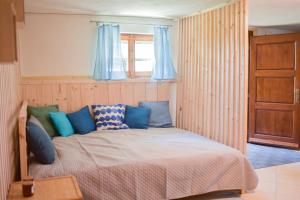 a bedroom with a bed with blue curtains at Chalupa na lúčnych kvetoch in Dobroč