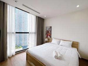Ένα ή περισσότερα κρεβάτια σε δωμάτιο στο Vinhomes Skylake Hanoi - CitiHome