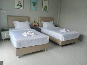 Postel nebo postele na pokoji v ubytování SeeView Resort (ซีวิว รีสอร์ต)