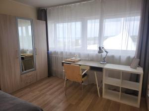 a bedroom with a desk and a window and a bed at Bright & Peaceful Room Near Old Town in Tallinn