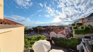 a view from the balcony of a building with an umbrella at Hotel Tritone in Trieste