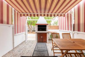 a dining room with a table and a stove at 1 BR Condo Chapelas Costa del Silencio AC Pool WIFI in Arona