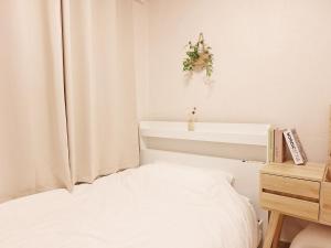 a bedroom with a bed and a plant on the wall at Hue stay 2 in Seoul