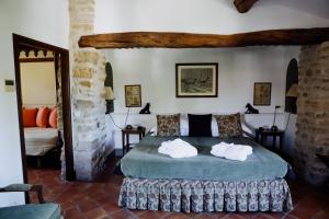 a bedroom with a large bed with two pillows at La Verrière in Crestet